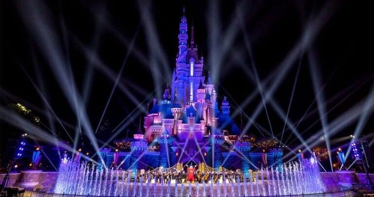 Spectacular Castle nighttime show with dazzling fountains and colorful lights illuminating Cinderella Castle at Magic Kingdom.