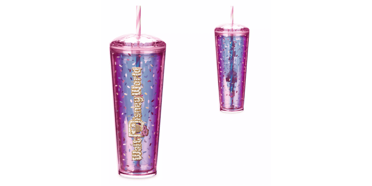A sparkling pink and blue tumbler with a lid and matching straw. The tumbler is shimmery with a gradient effect, featuring "Bath & Body Works" text and an abstract design from the Mickey Mouse Donut Collection. There are two images of the tumbler, one larger and a smaller one to the right.