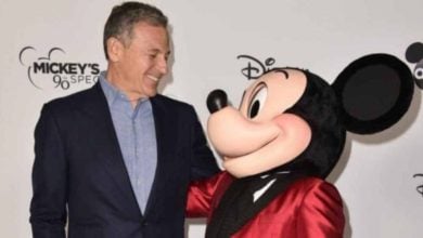 Mickey Mouse and Bob Iger smile at a Disney event.