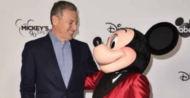 Mickey Mouse and Bob Iger smile at a Disney event.