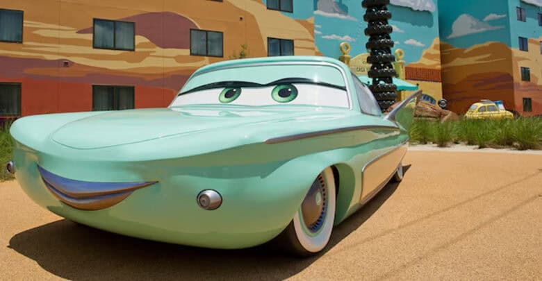 Cars welcomes guests outside a vibrant, cartoon-style building at Disney Resort, adding to the park’s playful charm.