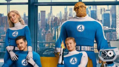 Fantastic Four in blue suits strike heroic poses before city windows, featuring Thing and Human Torch, teasing Marvel updates.