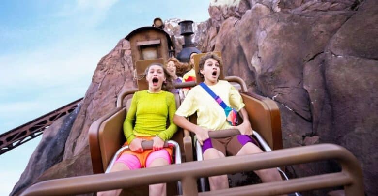Three Disney guests ride Expedition Everest.