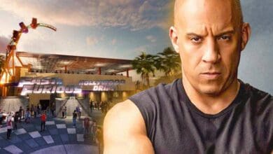 A guest in a sleeveless shirt stands at the entrance of Universal’s Fast & Furious: Hollywood Drift, with Express Pass Restriction signs nearby alerting visitors that access may be limited during busy periods.