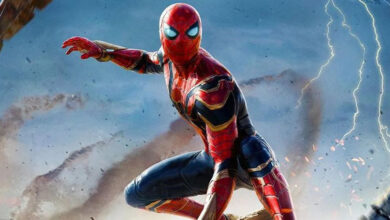 Spider-Man strikes an electrifying pose atop crumbled city ruins as lightning and debris fill the backdrop, showcasing his legendary agility and thrilling energy just like you’d experience at a live-action theme park attraction.
