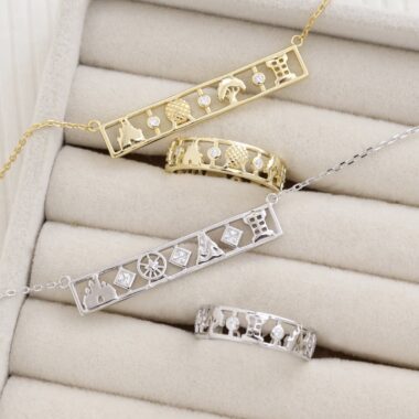 Elegant Disney-themed jewelry set featuring gold and silver necklaces and rings with Disney character silhouettes and motifs.