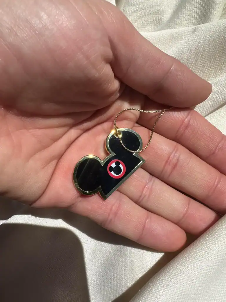 Gold Mickey Mouse pendant necklace with red and black eye design, Disney fashion jewelry accessory.