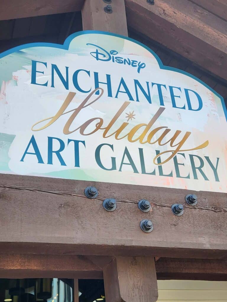 Enchanting Disney holiday art gallery sign with rustic wood frame and decorative lettering.
