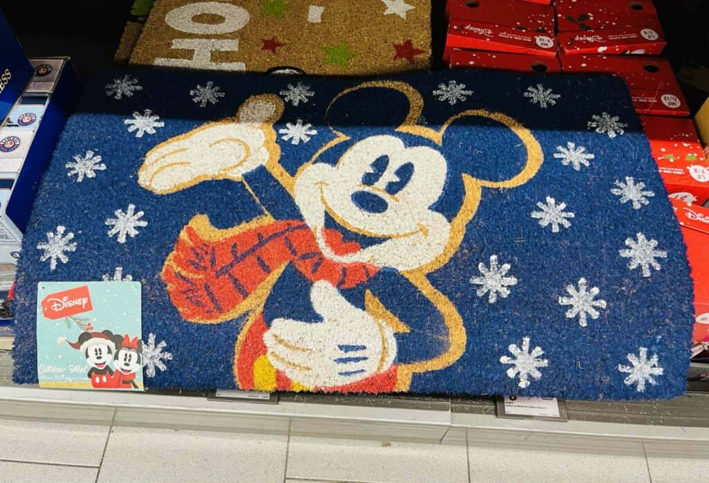 Cute Disney Mickey Mouse holiday outdoor mat with snowflake design and vibrant colors.