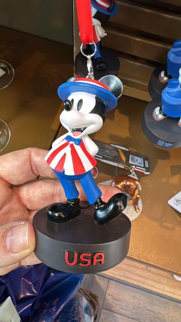 Colorful Mickey Mouse souvenir keychain with USA stand.