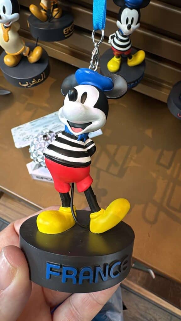 Whimsical Mickey Mouse souvenir with striped shirt, red shorts, yellow shoes & France inscription.