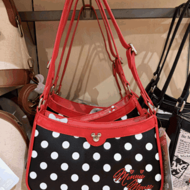 Polka dot Disney Minnie Mouse purse with red straps and Mickey Mouse detail.
