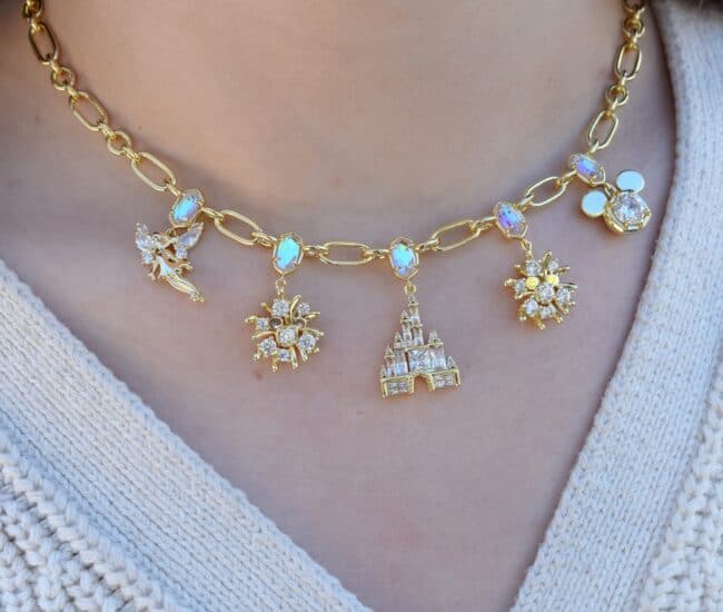 Disney jewelry, charm necklace, Disney-inspired jewelry, gold chain, sparkling charms, castle pendant, floral design.