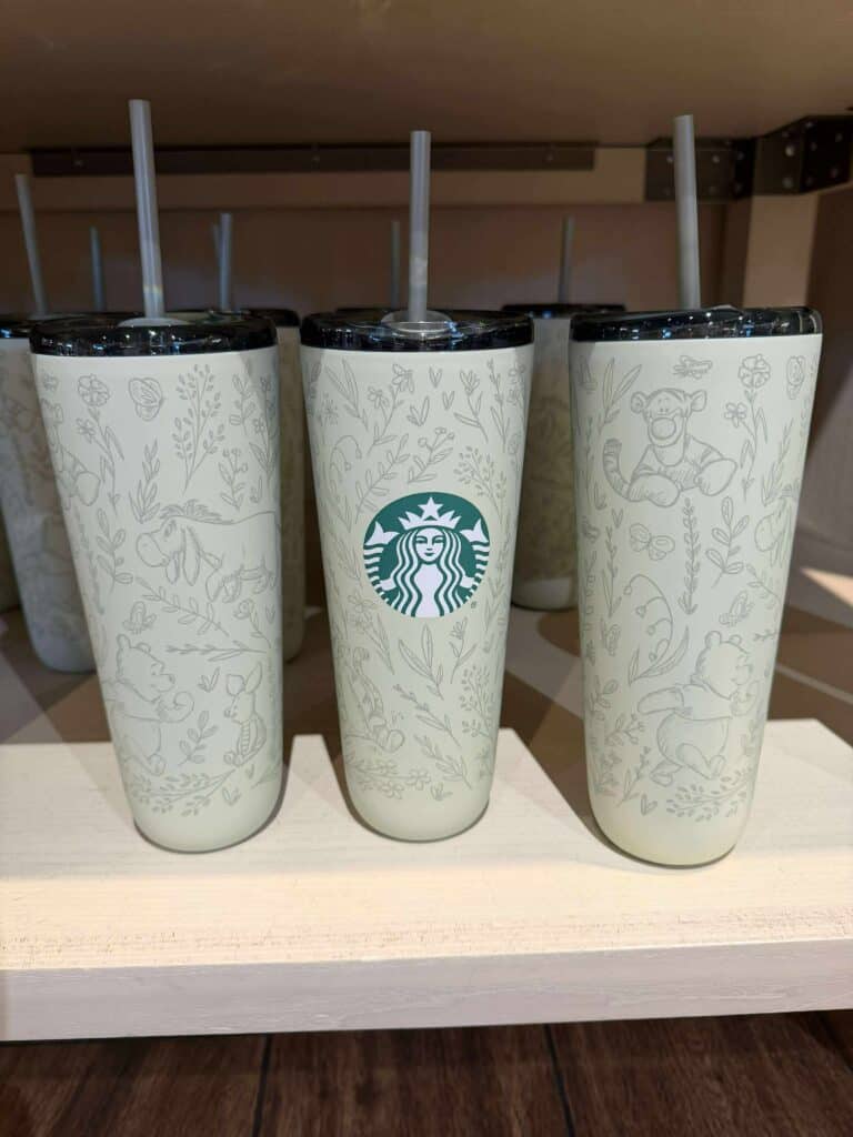 Stylish Disney Starbucks tumbler featuring adorable character sketches and the iconic logo.
