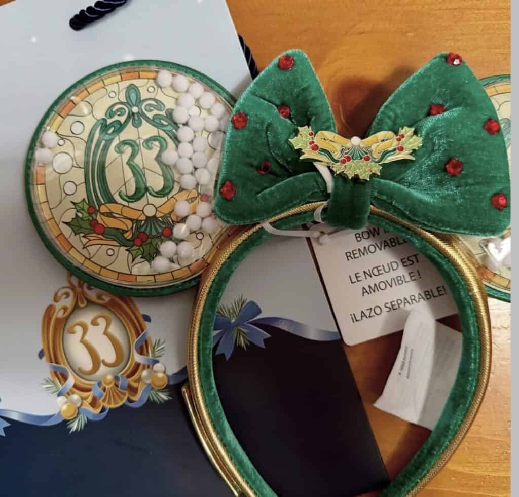 Christmas Disney headband with holly decoration and velvet bow, ideal for festive celebrations.
