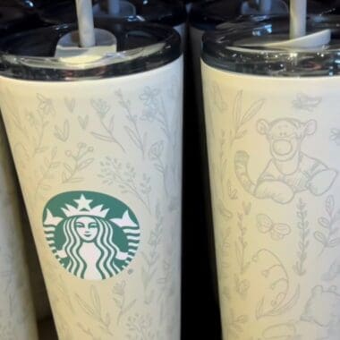 Stylish Disney-themed Starbucks tumbler featuring playful character sketches and floral designs, ideal for daily use.