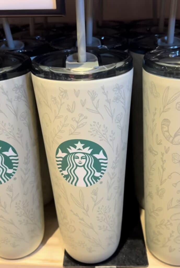 Elegant Starbucks tumbler with floral design, perfect for coffee lovers and Disney fans alike.
