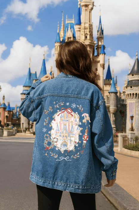 Stylish denim jacket with detailed Disney castle embroidery for Disney fans.