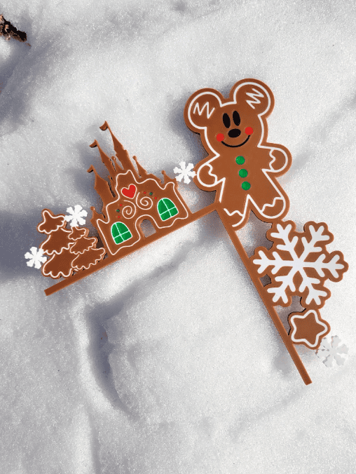 Colorful gingerbread and snowflake cake toppers on snow background. Perfect for holiday baking and Christmas celebrations.