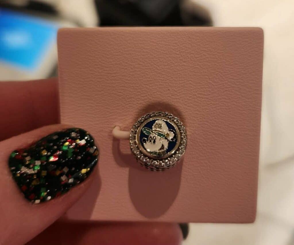 Details Minnie Mouse charm with rhinestones, perfect for Disney jewelry lovers.