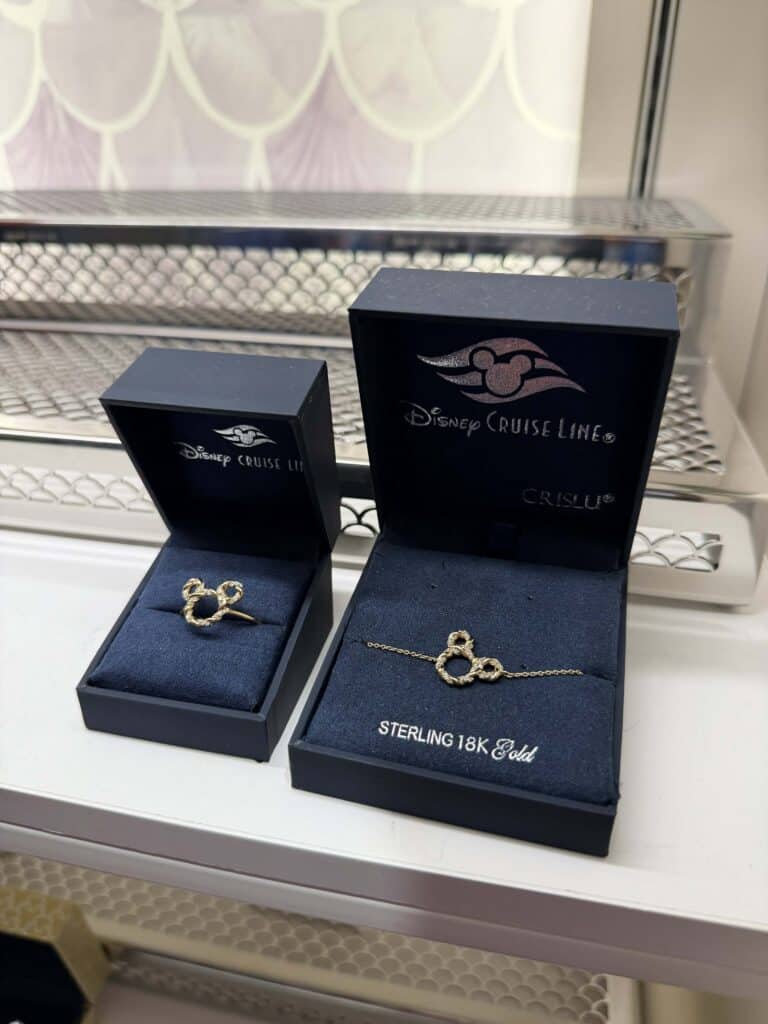 Elegant Mickey Mouse ring and bracelet in navy jewelry boxes, perfect Disney Cruise Line accessories.