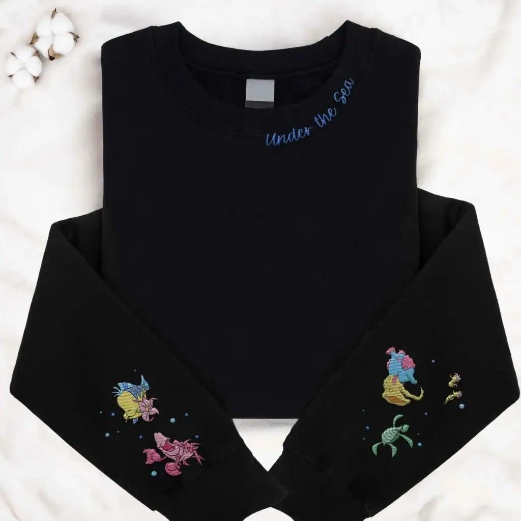 Disney fashion sweatshirt with embroidered sea creatures and "Under the Sea" message.