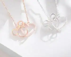 Elegant Mickey Mouse heart pendant necklaces in rose gold and silver. Perfect Disney-inspired jewelry for fans.