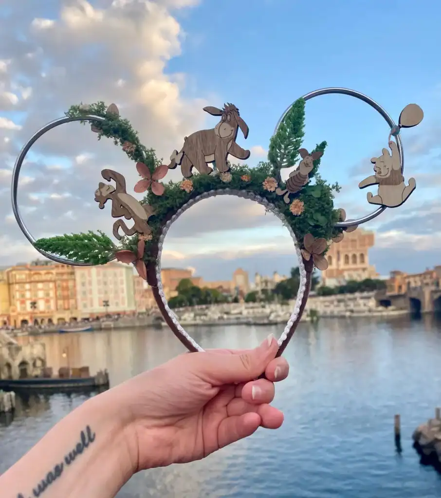 Disney-inspired woodland character headband with floral and greenery details, perfect for Disney fans.