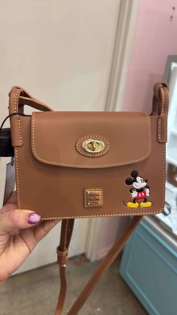 Mickey Mouse purse featuring Disney branding, leather material, and classic design for Disney fashion fans.