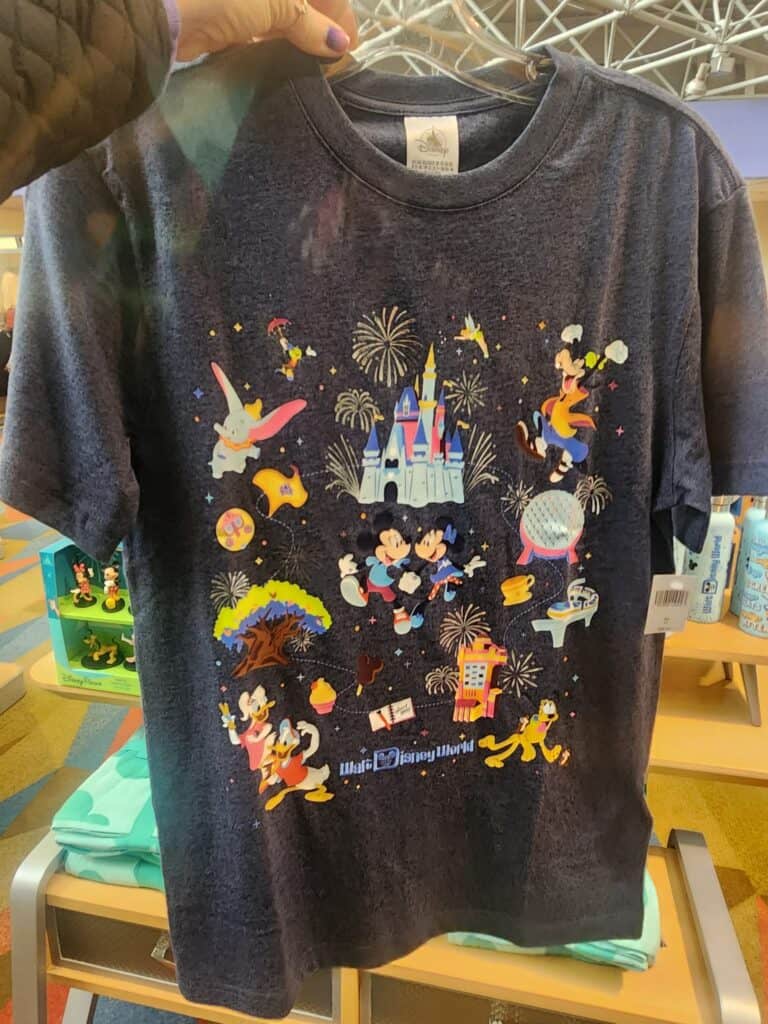 Colorful Disney theme T-shirt featuring Mickey Mouse, Minnie Mouse, and Disney castle with fireworks.
