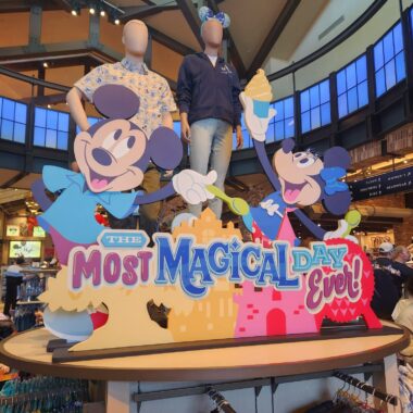 Colorful Disney-themed signage with Mickey and Minnie Mouse characters celebrating "The Most Magical Day Ever".