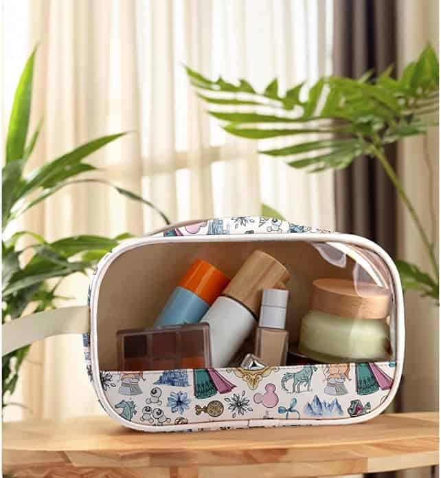 Travel skincare organizer with Disney-themed pattern, holding various skincare bottles and jars, ideal for travel and vanity.