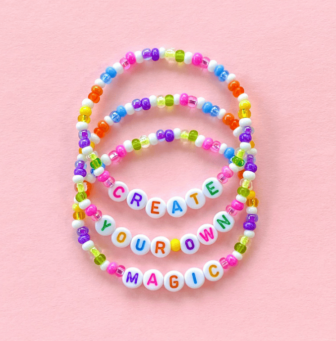 Colorful bead bracelets with "Create Your Magic" message, perfect Disney-inspired accessories.