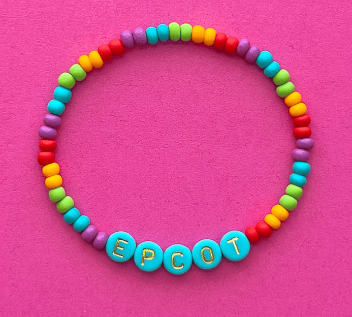 Colorful Disney-inspired bead bracelet with "EPCOT" spelling beads. Perfect Disney fan jewelry piece.