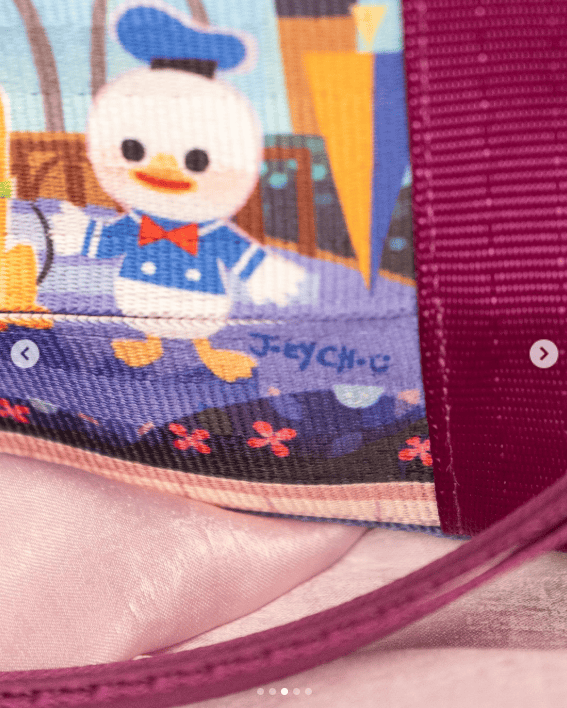 Colorful Donald Duck embroidered design on fabric backpack.