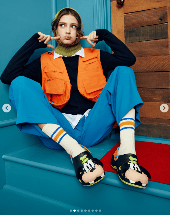 Bright, colorful Disney-themed outfit featuring Mickey Mouse slippers, sporty socks, and trendy layers.