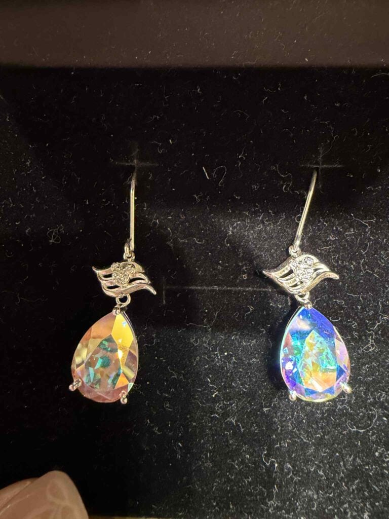 Stunning crystal earrings featuring a graceful swan and floral accents, ideal for Disney fashion enthusiasts.