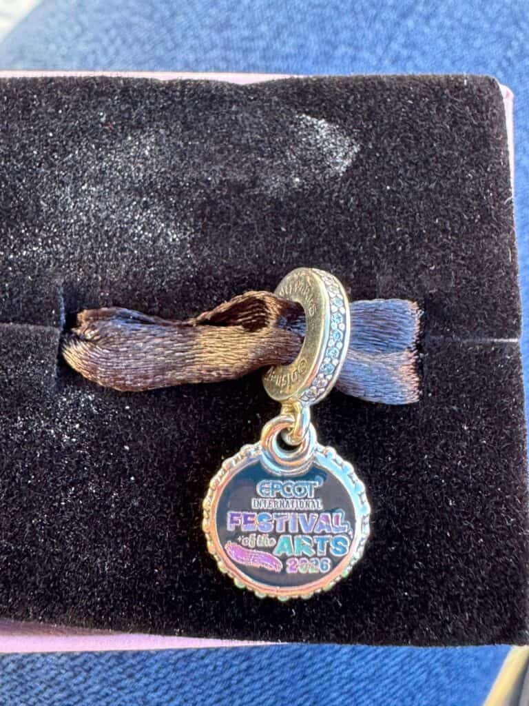 EPCOT International Festival of the Arts charm with colorful logo and rhinestones. Perfect Disney collectible jewelry piece.