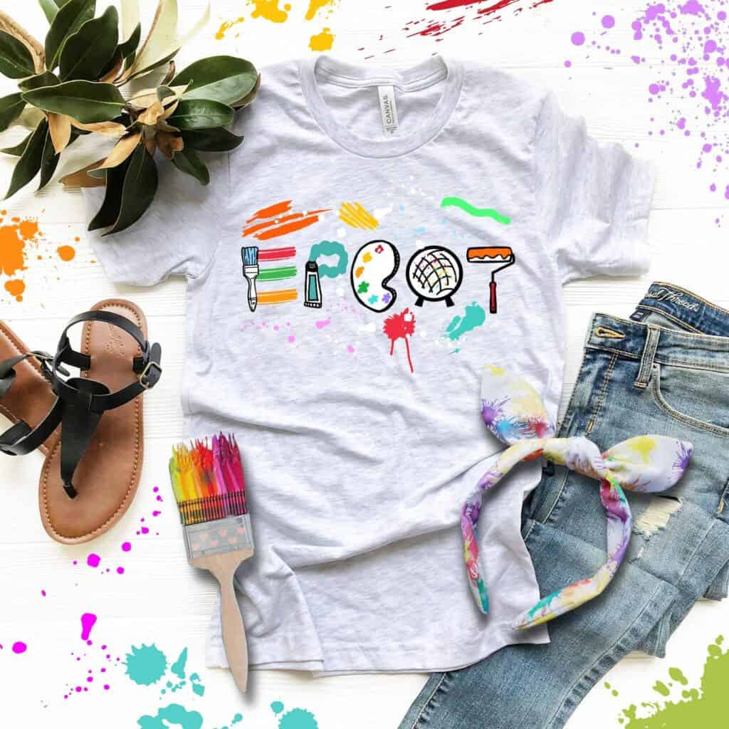 Bright Disney-inspired t-shirt featuring colorful art tools and creative graphics for fashion lovers.