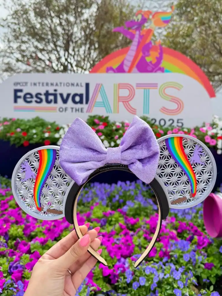 Disney-inspired rainbow Mickey ears headband with lavender bow for fans.