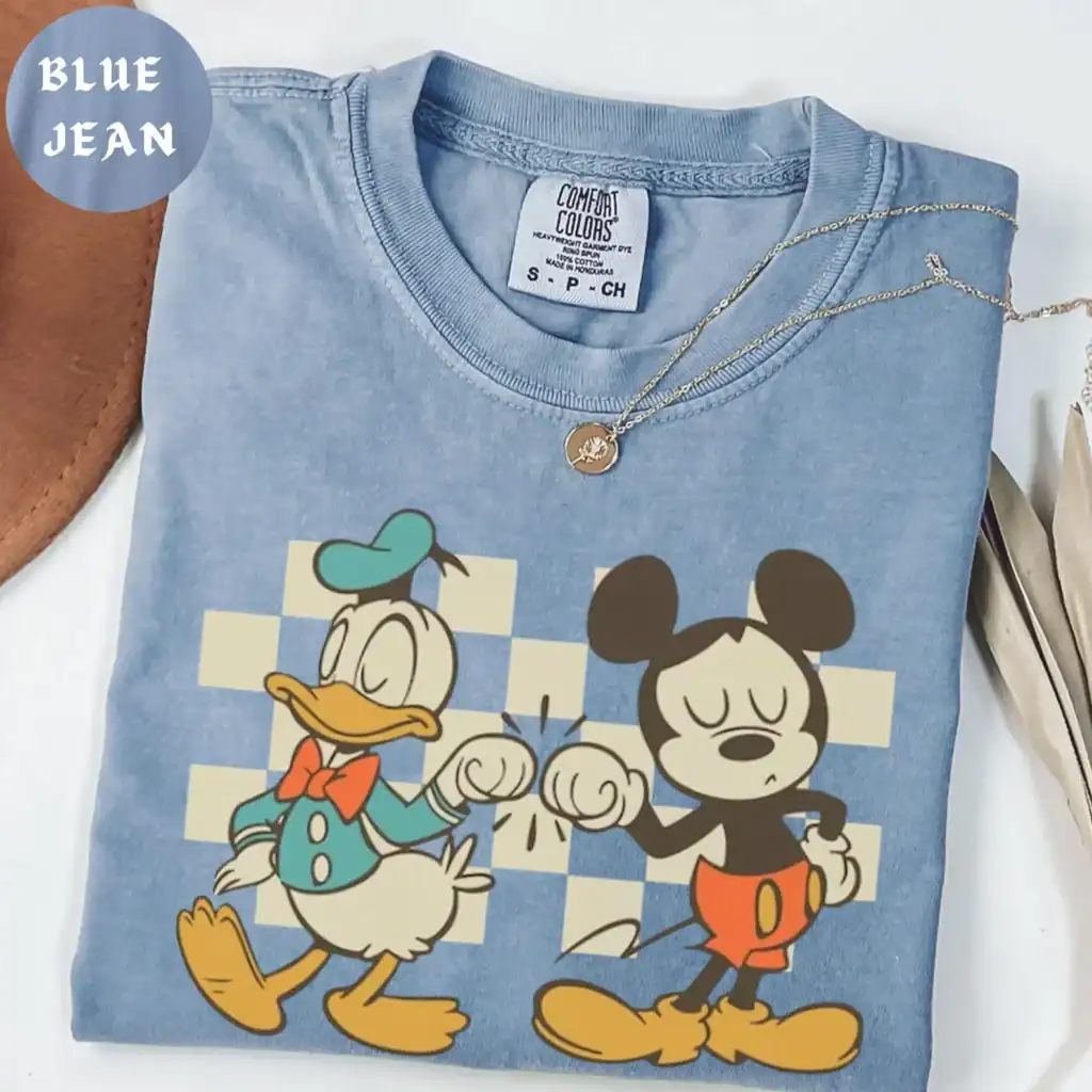 High-quality light blue Disney sweatshirt featuring Mickey and Minnie Mouse with a fun graphic, ideal for Disney fashion enthusiasts.