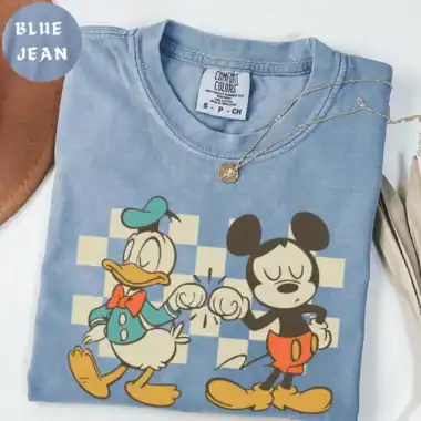 High-quality light blue Disney sweatshirt featuring Mickey and Minnie Mouse with a fun graphic, ideal for Disney fashion enthusiasts.