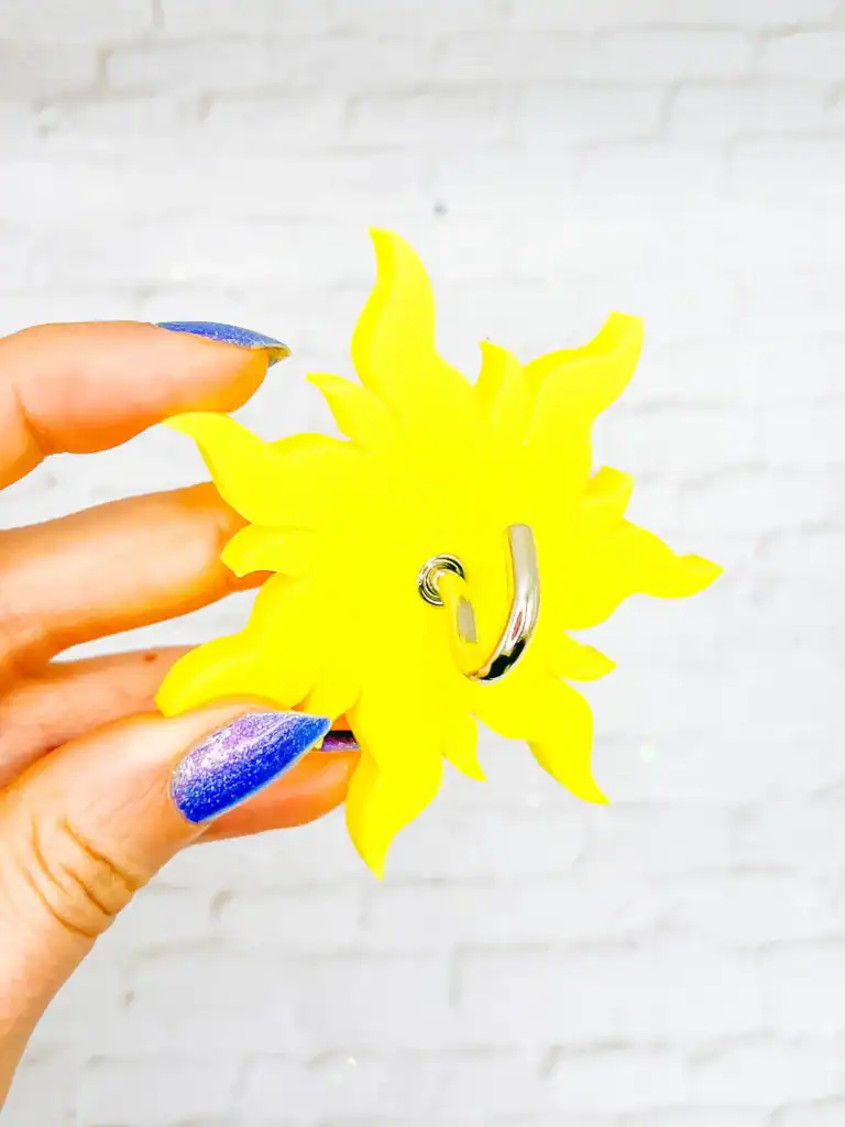 Bright yellow sunflower-shaped Disney-themed earring for fans and fashion lovers.