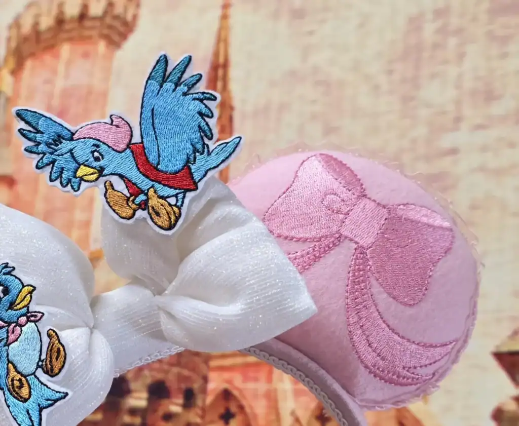 Embroidered Minnie Mouse hair clip with pink bow, coordinating with Disney-themed fashion accessories for women and children.