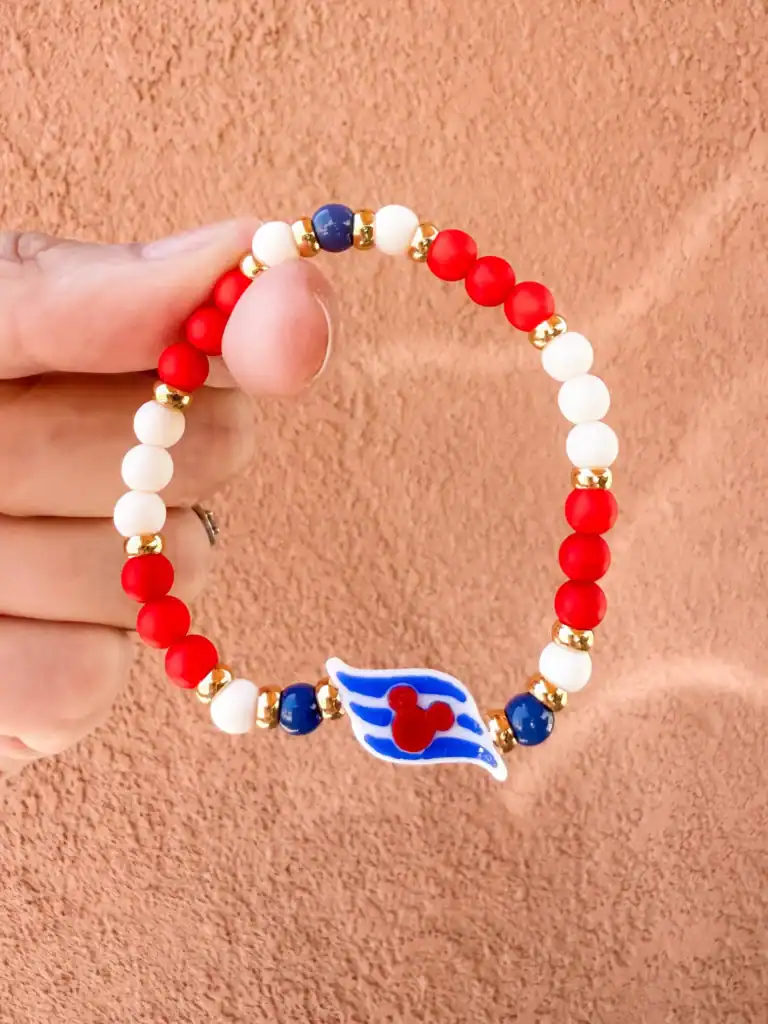 Bright red, white, and blue Disney-themed beaded bracelet with Mickey Mouse charm.