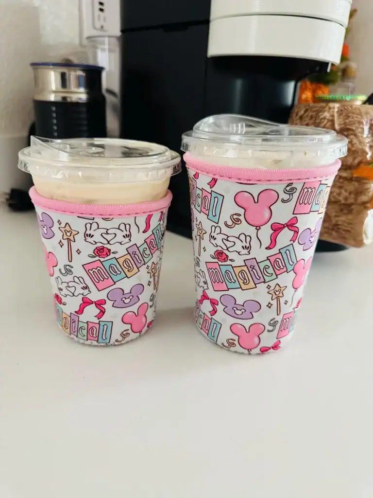 Disney-themed reusable travel mugs with Minnie Mouse designs, pink accents, and secure lids.