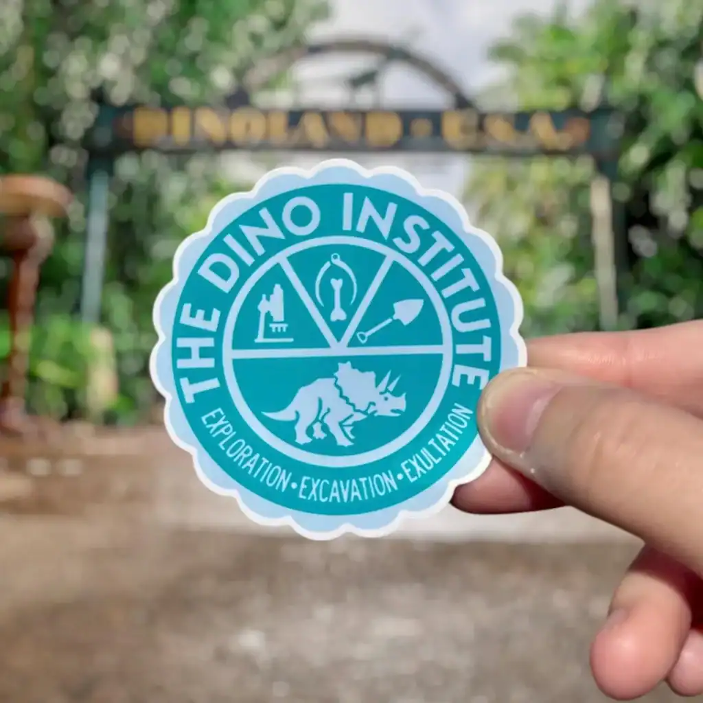 Colorful Dino Institute sticker with dino and tools, perfect for Disney fans.