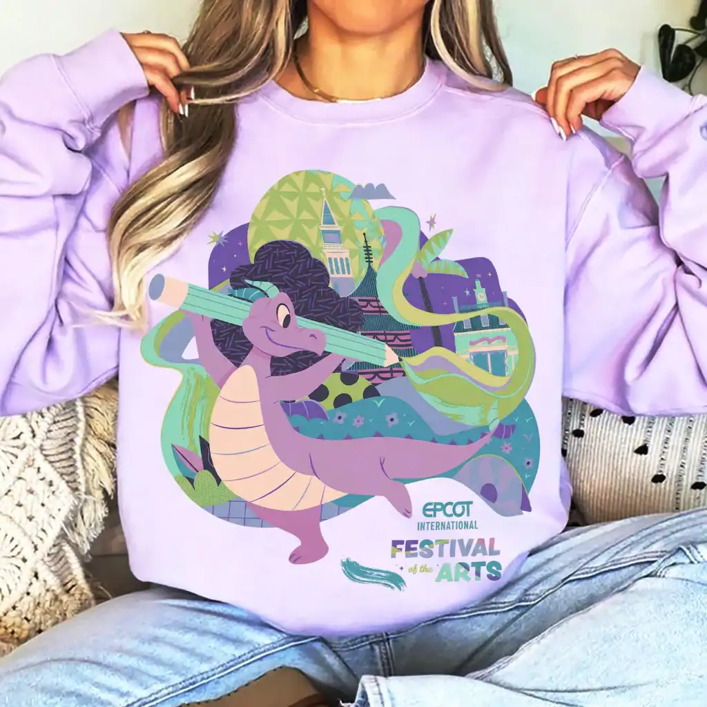 Colorful, Disney-themed arts festival graphic on lavender sweatshirt showcasing creativity and imagination.