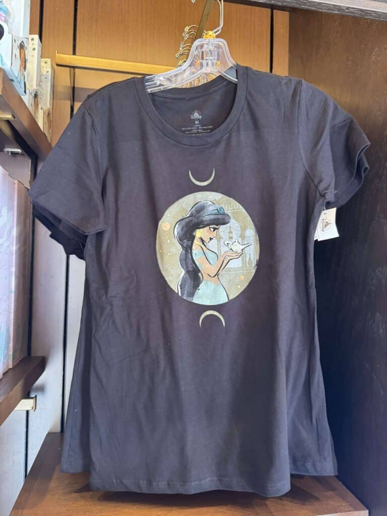 Black T-shirt featuring a witch with a moon and stars design, perfect for Disney fans.
