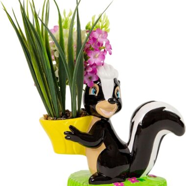 Cute skunk-shaped plant holder with pink flowers and green pot for St. Patrick's Day.
